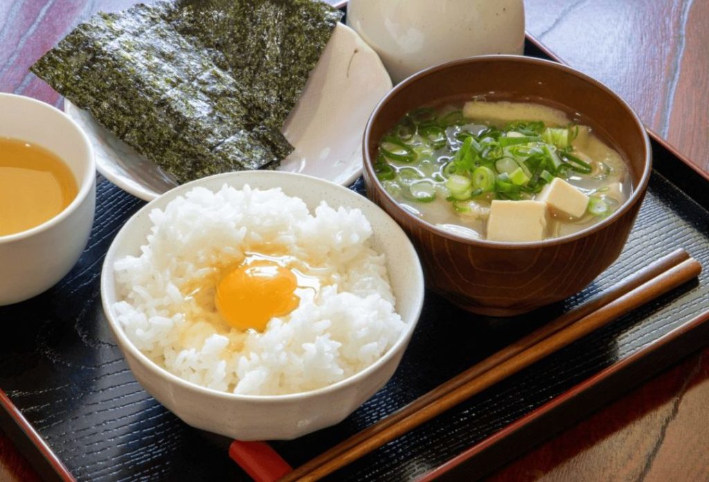 Japanese breakfast consists of steamed rice with raw egg and miso soup
