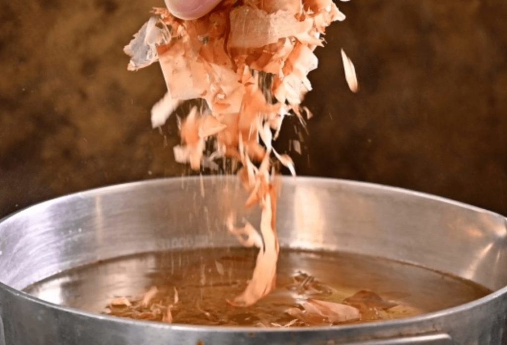 Thinly shaved bonito flakes are added to boiling water to make miso soup