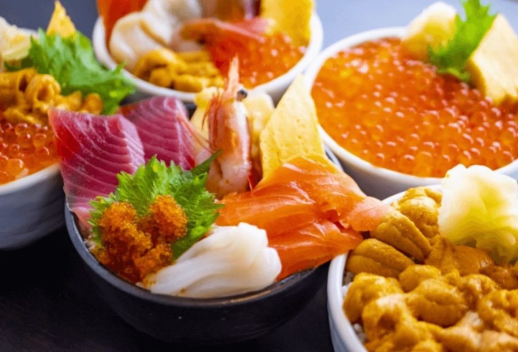 Kaisen-don (seafood rice bowl ) topped with tuna, shrimp, salmon, and other seafood.