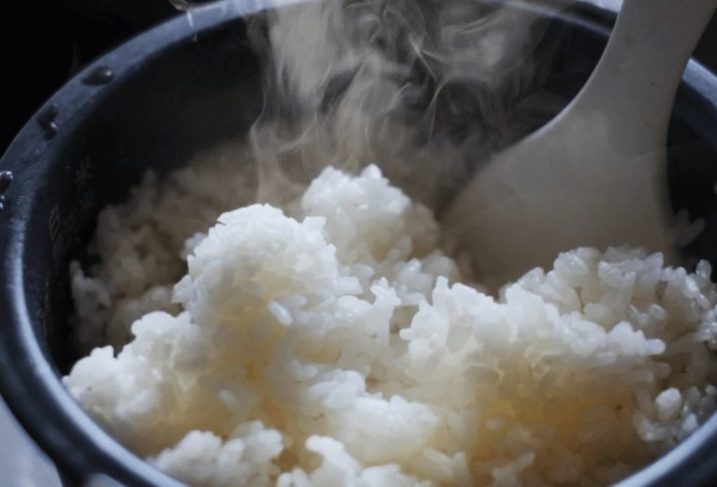Freshly cooked rice with steam rising from it