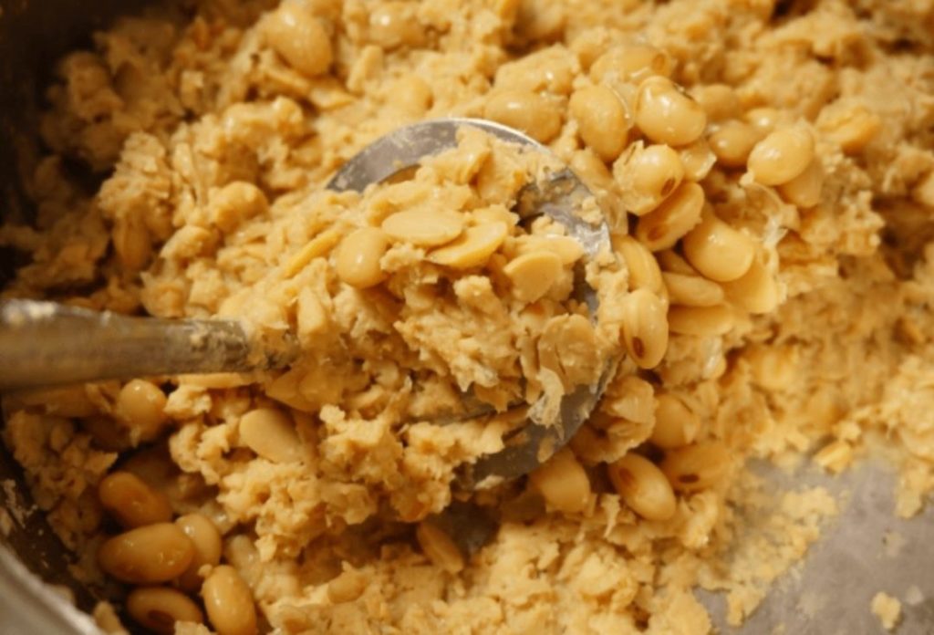 Soybeans ground into a paste in a mortar